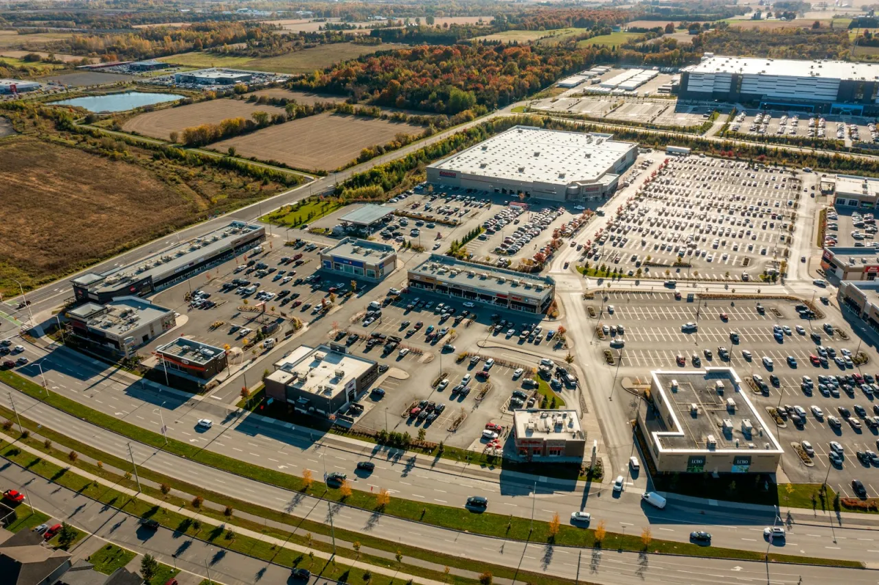Aerial view of a suburban shopping plaza with anchor stores and busy parking lots