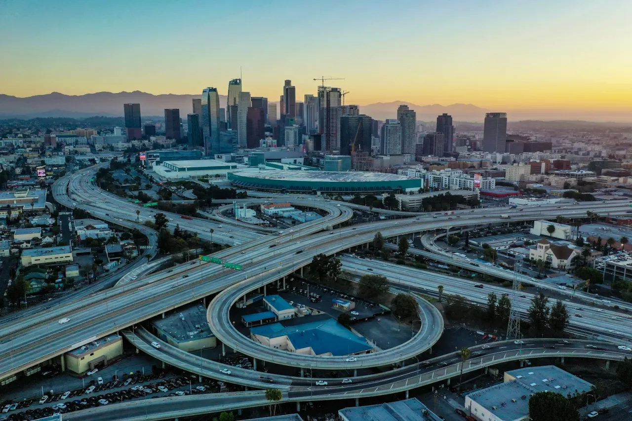Aerial view of the downtown Los Angeles skyline with freeway interchange at golden hour