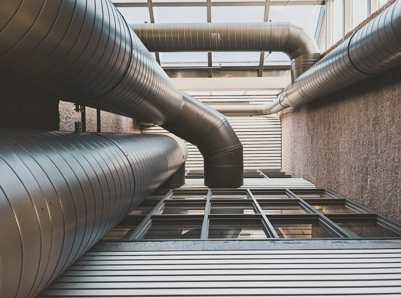 Large commercial HVAC ductwork running between industrial buildings