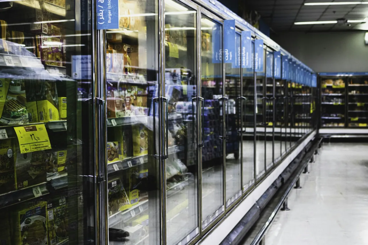 Glass-door commercial refrigerated display cases in a grocery aisle